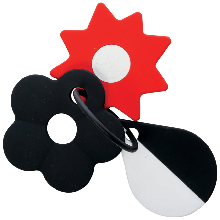 A set of silicone shapes attached to a plastic ring, including a red star, black flower, and white teardrop.